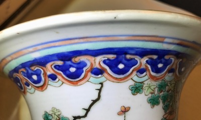 A tall Chinese famille rose vase with a court scene and peacocks, 19th C.