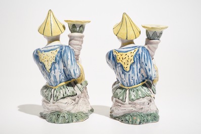 A pair of polychrome Brussels faience candlesticks modelled as chinamen, ca. 1800