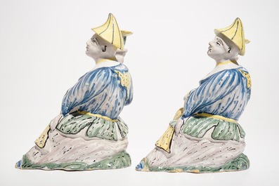 A pair of polychrome Brussels faience candlesticks modelled as chinamen, ca. 1800