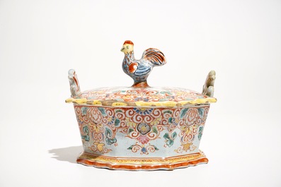 A polychrome Dutch Delft petit feu butter tub with a rooster-topped cover, 18th C.