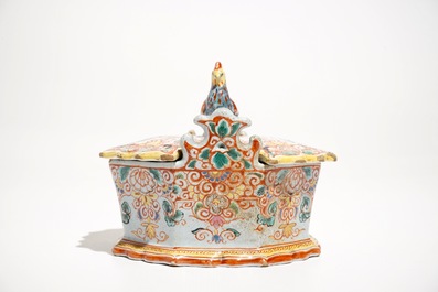 A polychrome Dutch Delft petit feu butter tub with a rooster-topped cover, 18th C.