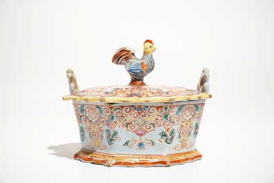 A polychrome Dutch Delft petit feu butter tub with a rooster-topped cover, 18th C.