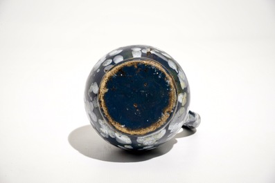 A French faience jug with blue ground "A la bougie" design, Nevers, 17th C.