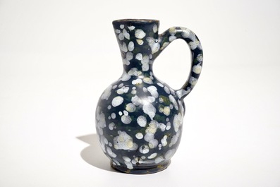 A French faience jug with blue ground "A la bougie" design, Nevers, 17th C.