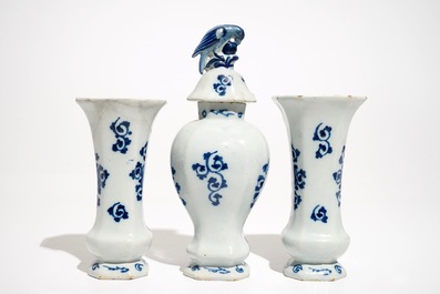 A Dutch Delft blue and white three-piece garniture with a naval scene, 18th C.