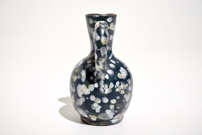 A French faience jug with blue ground "A la bougie" design, Nevers, 17th C.