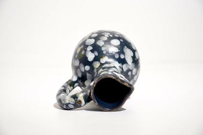 A French faience jug with blue ground "A la bougie" design, Nevers, 17th C.