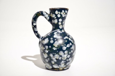 A French faience jug with blue ground "A la bougie" design, Nevers, 17th C.