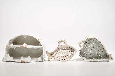 A white Dutch Delft letter holder and two strainers, 18th C.