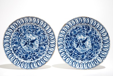 A pair of Dutch Delft blue and white dishes with cherubs and two sugar pots, 18th C.