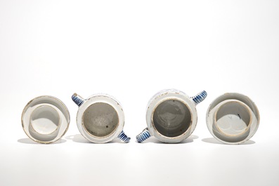 A pair of Dutch Delft blue and white dishes with cherubs and two sugar pots, 18th C.