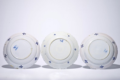 A pair of Dutch Delft blue and white "Tea Tree" dishes and a dish with a flower basket, 18th C.