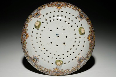 A polychrome Dutch Delft tripod strawberry strainer, 18th C.
