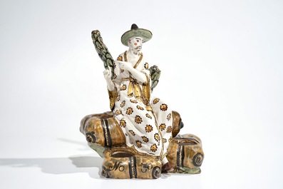 A French faience ink stand modelled as a seated Chinese, Lille, 18th C.