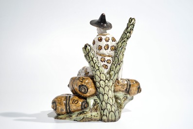 A French faience ink stand modelled as a seated Chinese, Lille, 18th C.