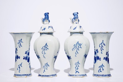 A fine Dutch Delft blue and white four-piece garniture with a farmer, 2nd half 18th C.