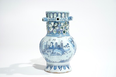 A Dutch Delft blue, white and manganese chinoiserie puzzle jug, dated 1690