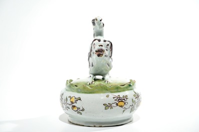 A polychrome Dutch Delft butter tub with a dog, 18th C.