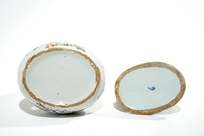A polychrome Dutch Delft butter tub with a dog, 18th C.