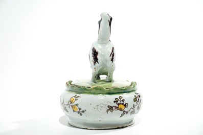 A polychrome Dutch Delft butter tub with a dog, 18th C.
