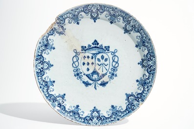 Seven Dutch Delft blue and white plates and a large armorial dish, 17/18th C.