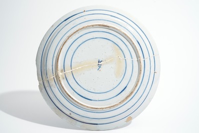 Seven Dutch Delft blue and white plates and a large armorial dish, 17/18th C.