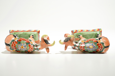 A pair of polychrome Dutch Delft petit feu cows on bases, 18th C.