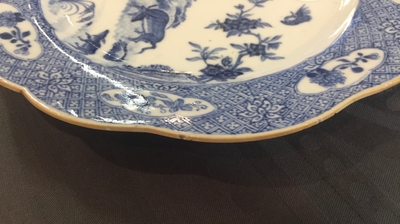 A pair of Chinese blue and white plates with animals in a garden, Qianlong