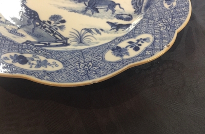 A pair of Chinese blue and white plates with animals in a garden, Qianlong