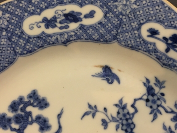 A pair of Chinese blue and white plates with animals in a garden, Qianlong