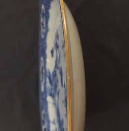 A pair of Chinese blue and white plates with animals in a garden, Qianlong