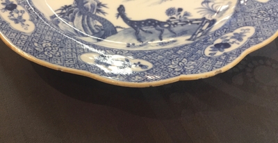 A pair of Chinese blue and white plates with animals in a garden, Qianlong