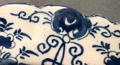 A pair of Dutch Delft blue and white "Tea Tree" dishes and a dish with a flower basket, 18th C.