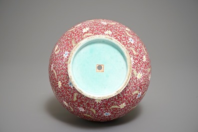 A Chinese ruby-ground famille rose bottle vase with dancing boys, Qianlong mark, 19/20th C.