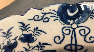 A pair of Dutch Delft blue and white "Tea Tree" dishes and a dish with a flower basket, 18th C.