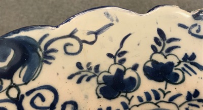A pair of Dutch Delft blue and white "Tea Tree" dishes and a dish with a flower basket, 18th C.