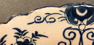 A pair of Dutch Delft blue and white "Tea Tree" dishes and a dish with a flower basket, 18th C.