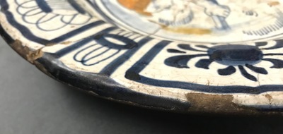A rare Dutch Delft or Haarlem maiolica dish with a putto, 1st half 17th C.