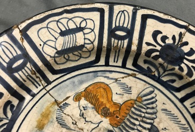 A rare Dutch Delft or Haarlem maiolica dish with a putto, 1st half 17th C.