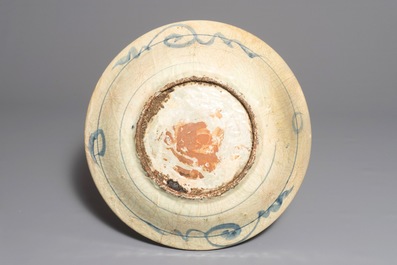 A large Chinese blue and white Swatow dish with a boat in a landscape, Ming