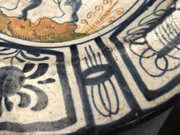 A rare Dutch Delft or Haarlem maiolica dish with a putto, 1st half 17th C.