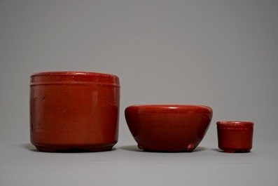 Two Chinese oxblood-glazed brush pots and an incense burner, 19/20th C.