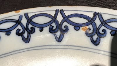 A Dutch Delft blue and white armorial plate, 17th C.