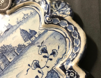 A Dutch Delft blue and white plaque with a lady in a landscape, 18th C.