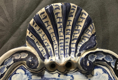A Dutch Delft blue and white plaque with a lady in a landscape, 18th C.