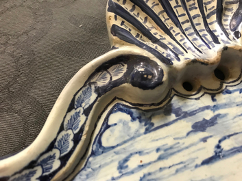 A Dutch Delft blue and white plaque with a lady in a landscape, 18th C.