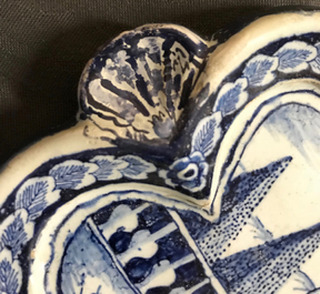 A Dutch Delft blue and white plaque with a lady in a landscape, 18th C.