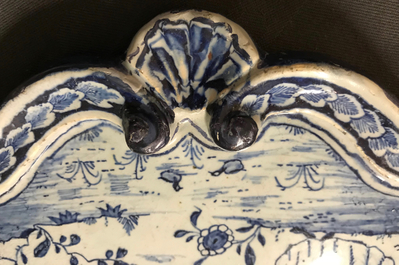 A Dutch Delft blue and white plaque with a lady in a landscape, 18th C.