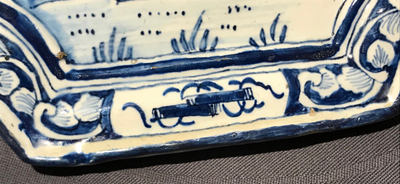 A Dutch Delft blue and white plaque with birds among flowers, 18th C.