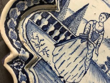 A Dutch Delft blue and white plaque with a lady in a landscape, 18th C.